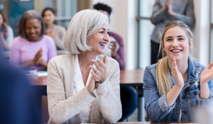 People clapping for a presenter in the classroom