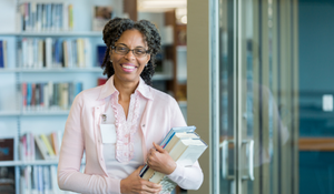 Librarian posing for a picture in their library