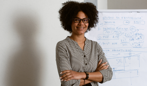 Teacher posing at the front of their classroom
