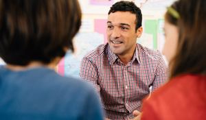 Teacher speaking with their young students during class