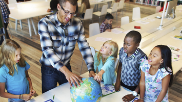 Teacher instructing their students while using a Lightspeed Flexmike for instructional audio in the classroom