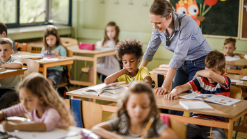 Teacher using their Flexmike in the classroom while working with their students