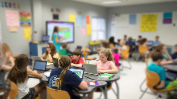 Diverse students working with their teaching in the classroom