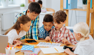 Young diverse students working on a project together in the classroom